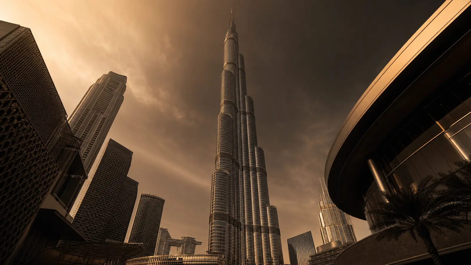 Downtown Dubai skyline viewed from near the base of the Burj Khalifa at dusk