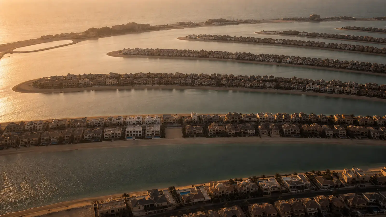 Aerial view of Palm Jumeirah's fronds with beachfront villas and the sea