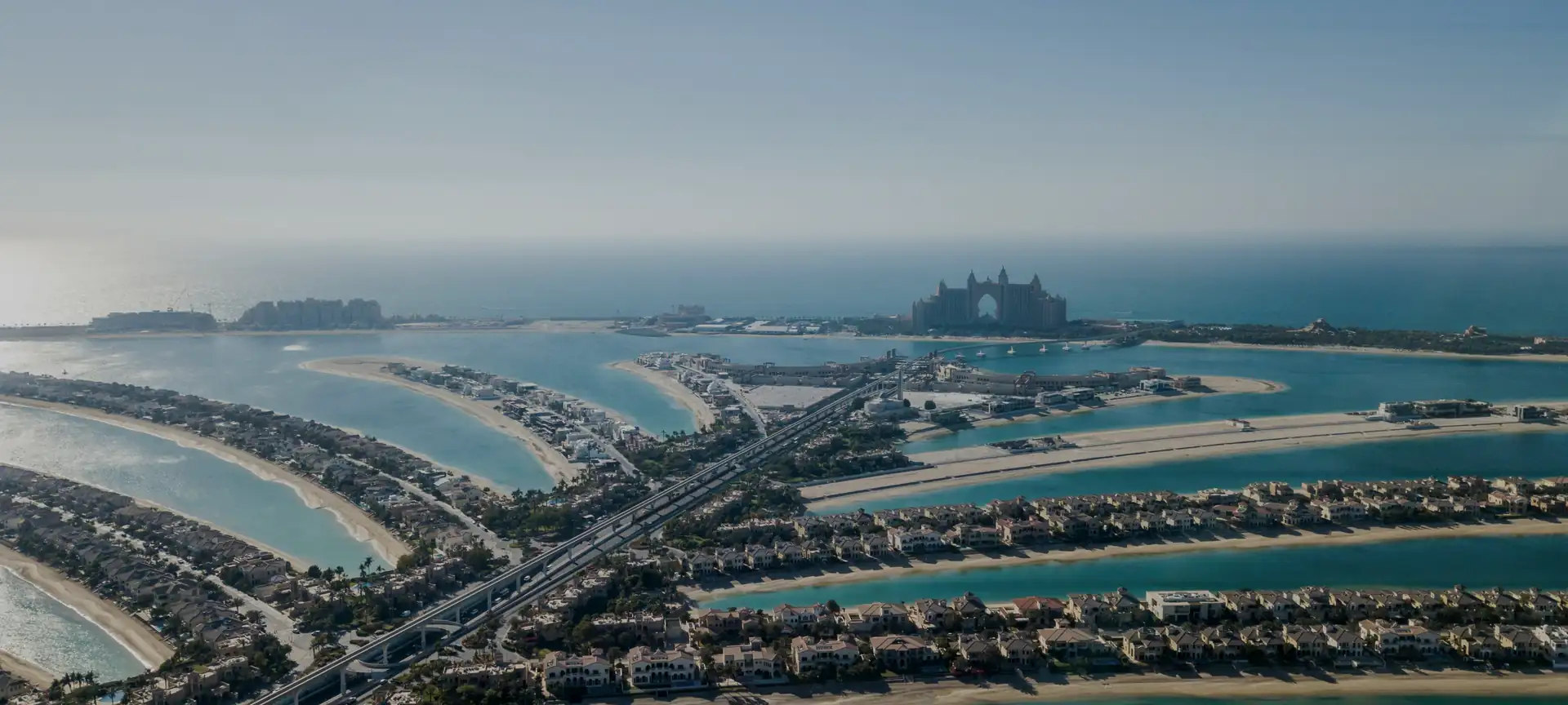 Aerial view of Palm Jumeirah in Dubai, with its beachfront villas and the bay