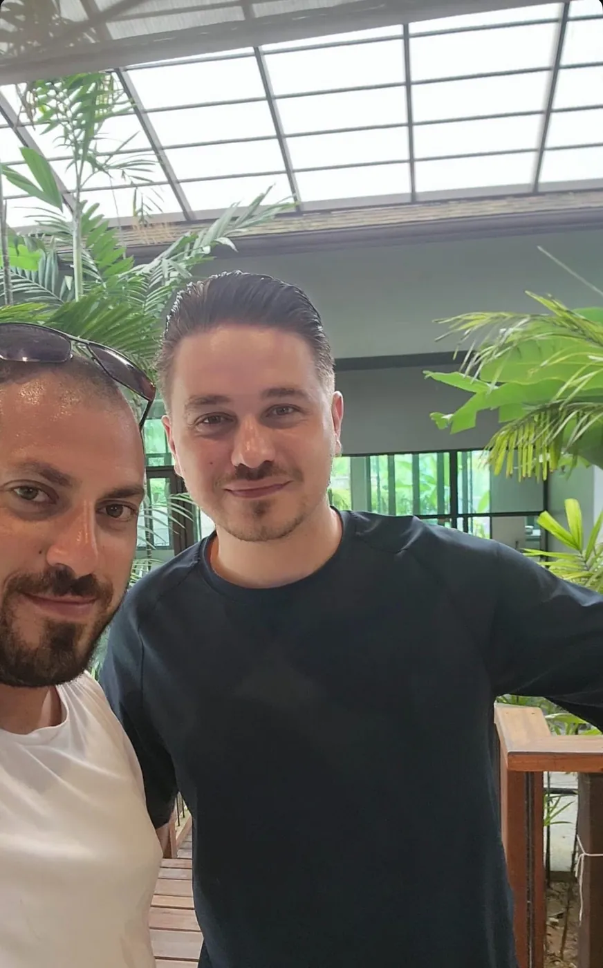 A client and a ProEstate broker in a glass-roofed atrium in Dubai