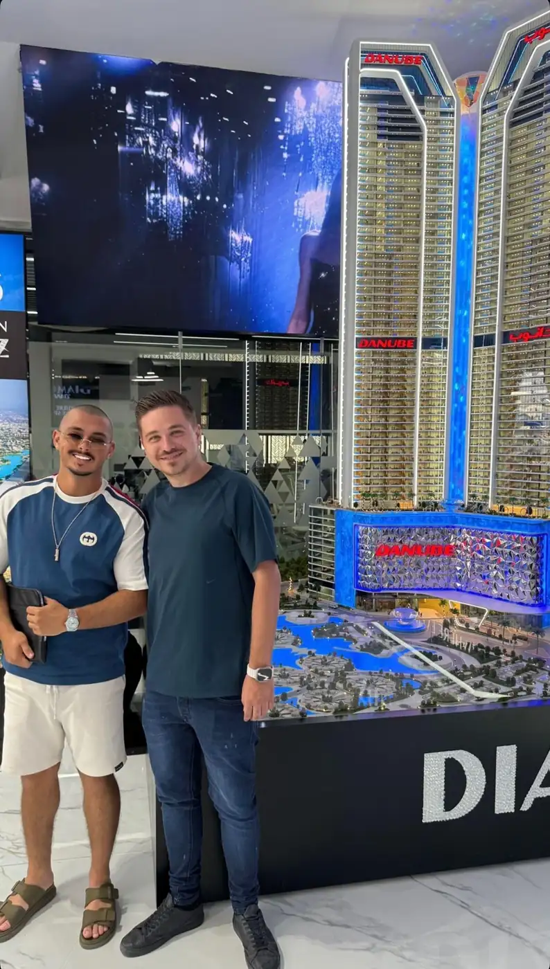 Clients and a ProEstate broker at a developer sales gallery in Dubai: Diamondz by Danube
