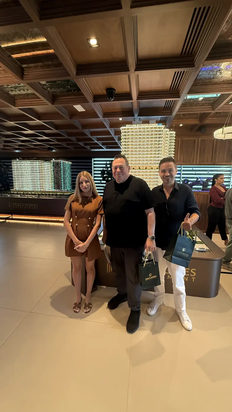 Clients and a ProEstate broker at a developer sales gallery in Dubai: Sky Line by Peace Homes